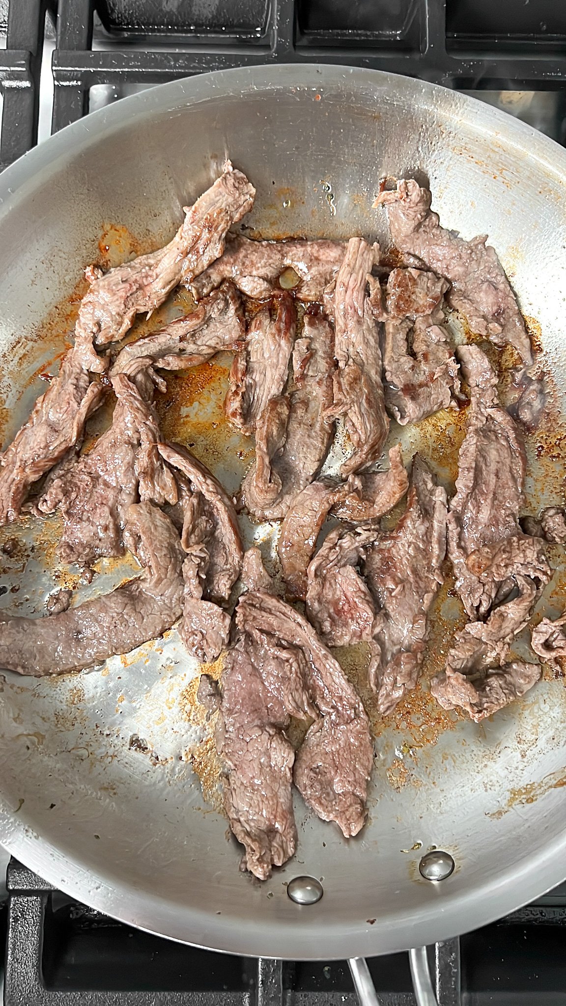 flank steak searing in pan