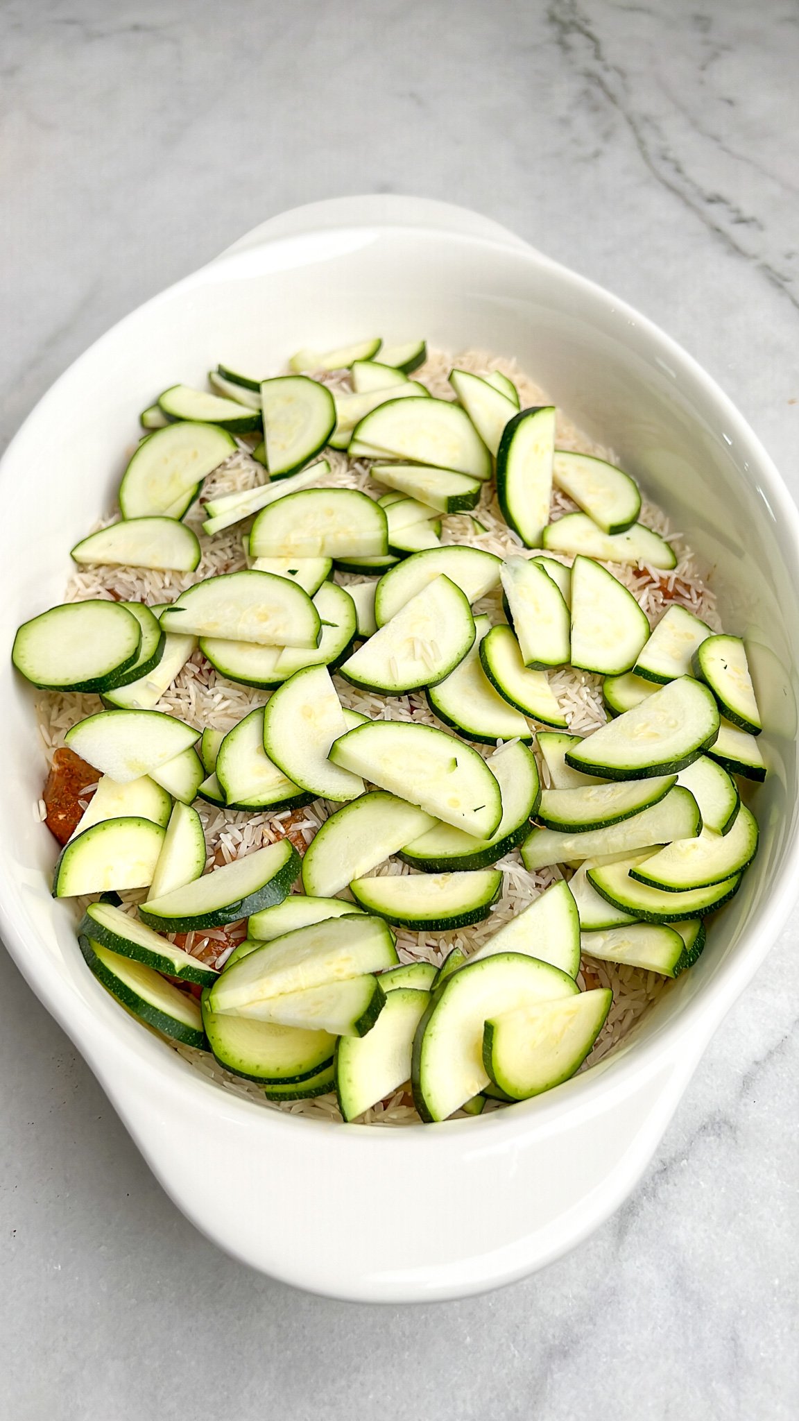 zucchini added to casserole dish over rice and chicken