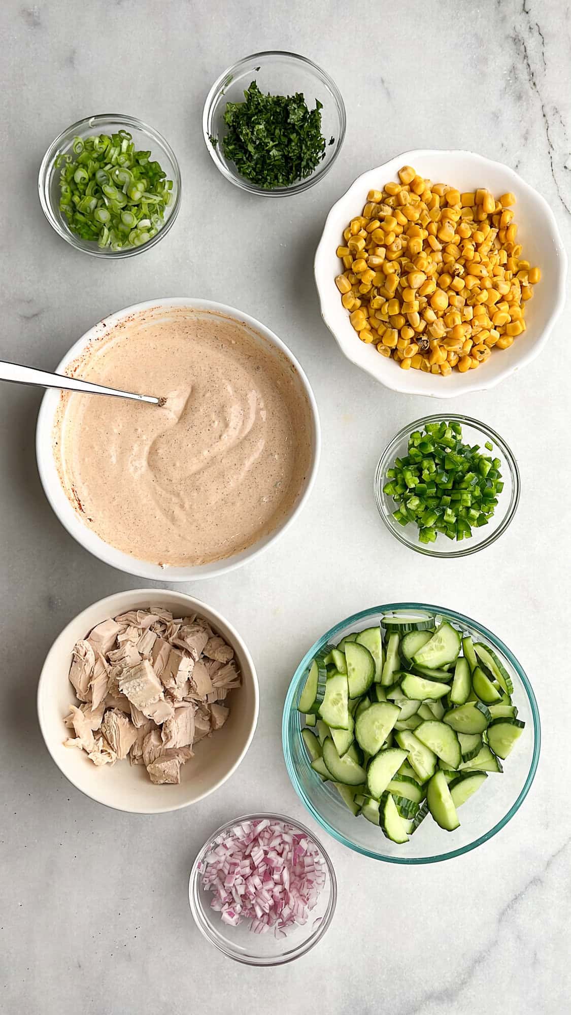 ingredients measured out for creamy cucumber salad