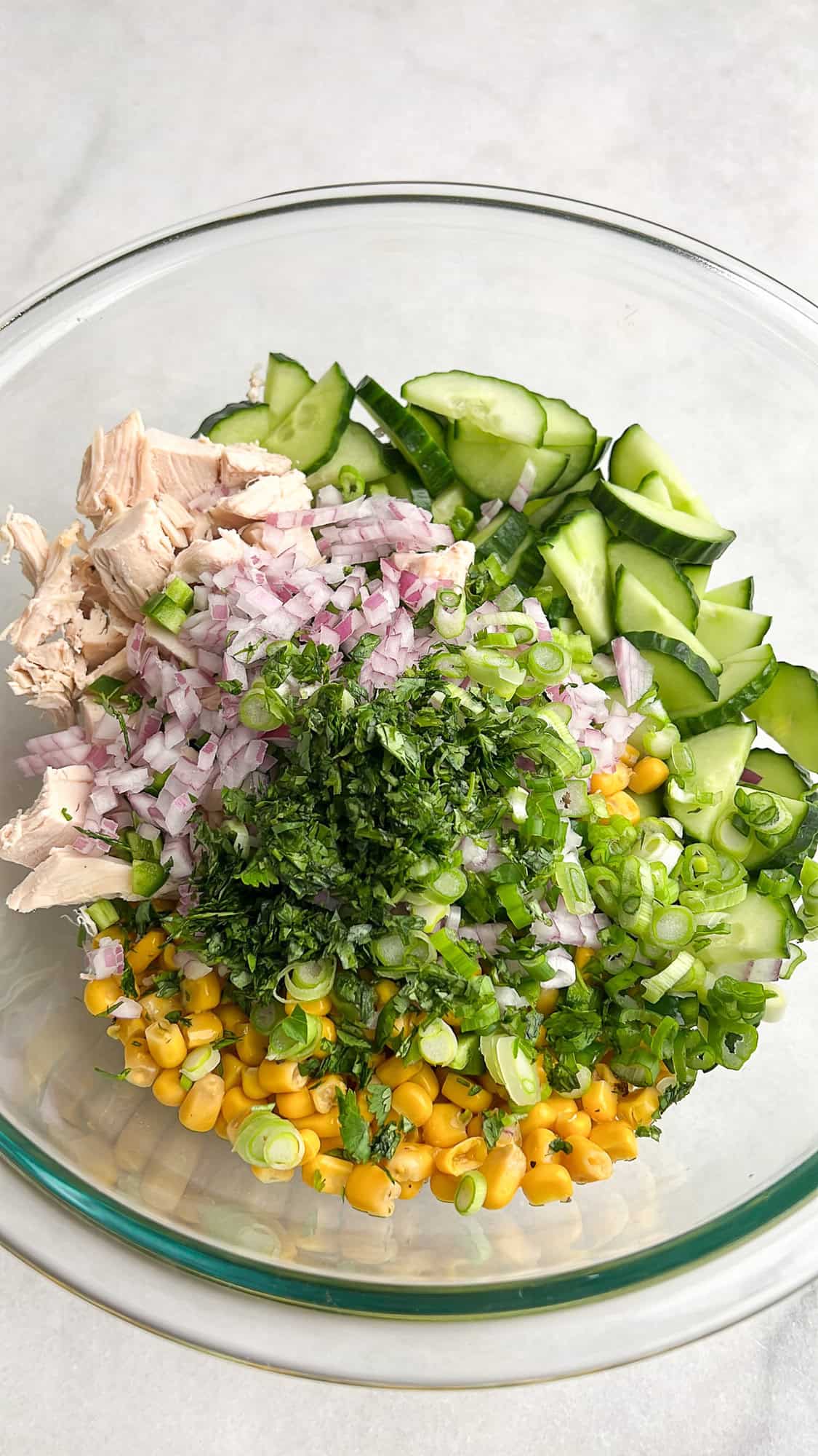 ingredients for creamy cucumber salad in a bowl