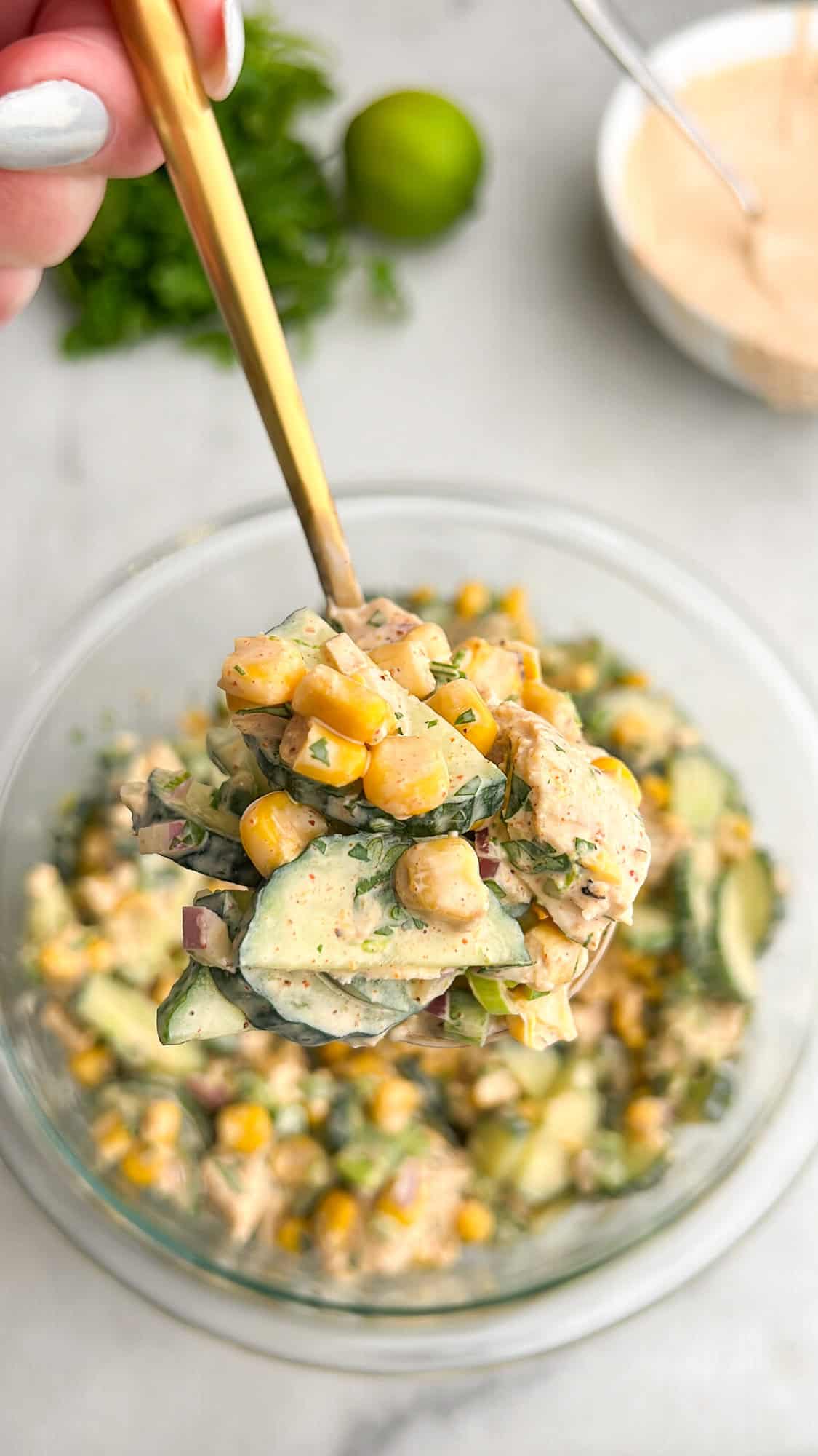 creamy cucumber salad on a spoon