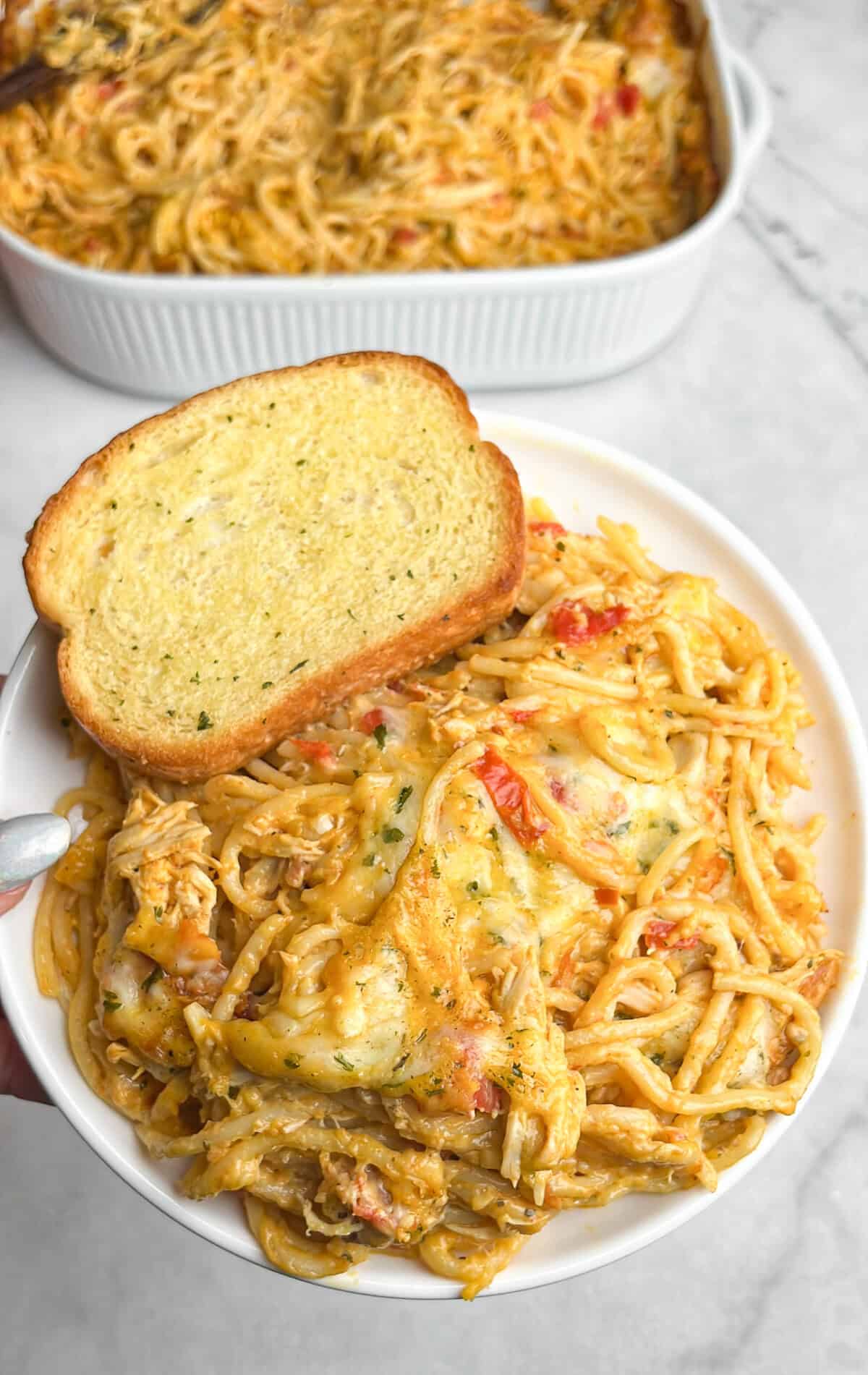 chicken spaghetti with rotel on a plate with texas toast