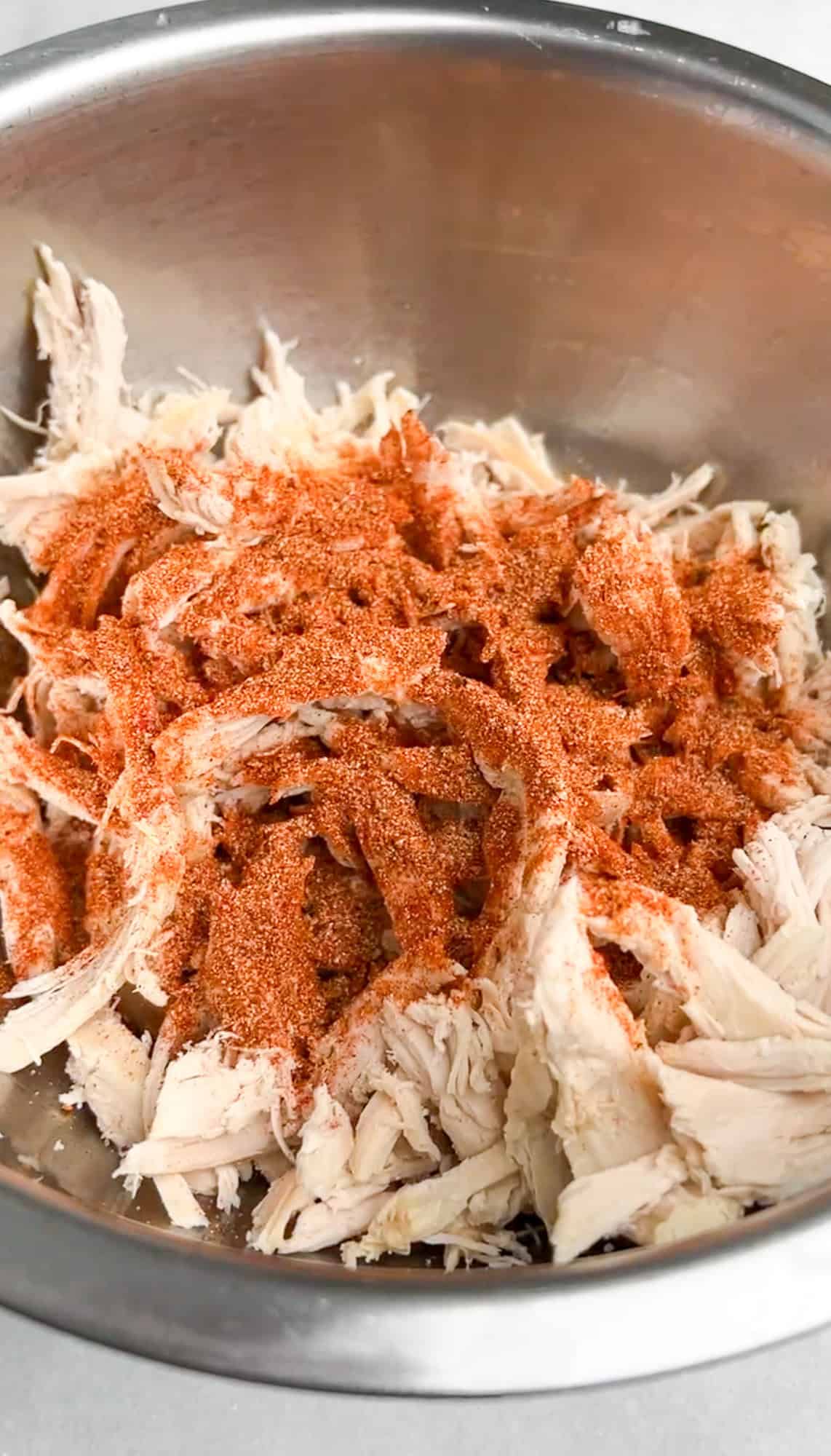 chicken in a bowl with seasonings