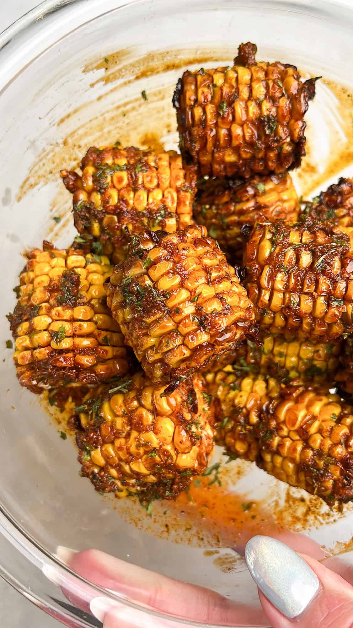 An air-fried copycat recipe for Wingstop Cajun fried corn smothered in a Cajun butter sauce, making it the perfect appetizer or side dish. Copycat Wingstop cajun corn in a large bowl