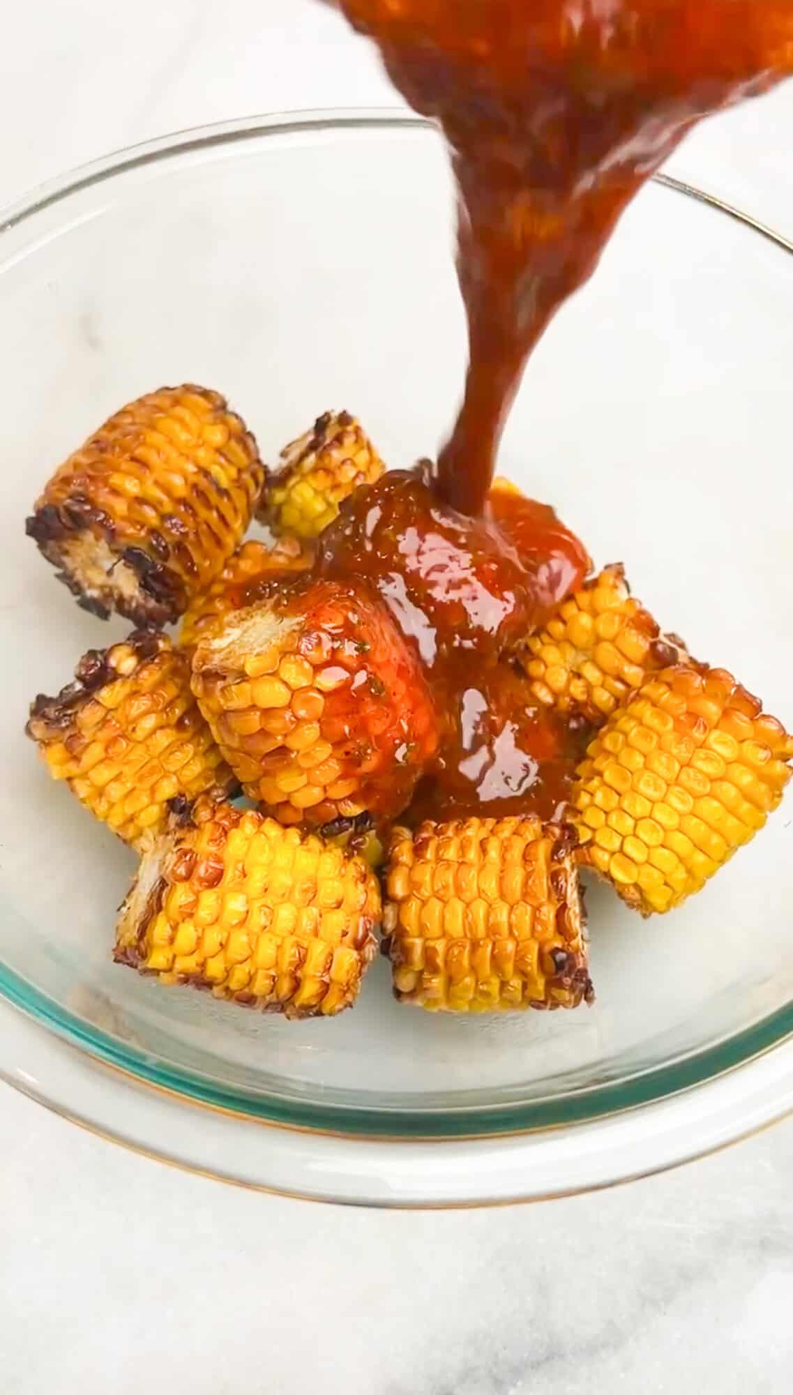 melted butter pouring over corn