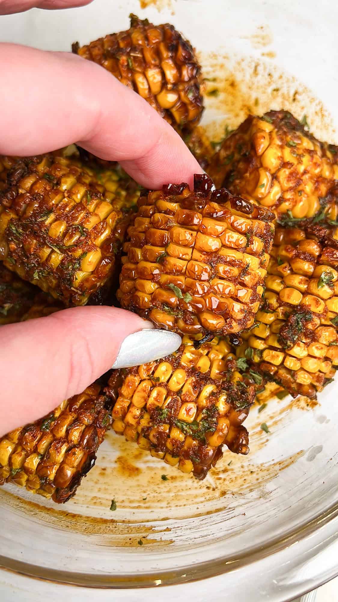 corn covered in cajun butter in a large bowl