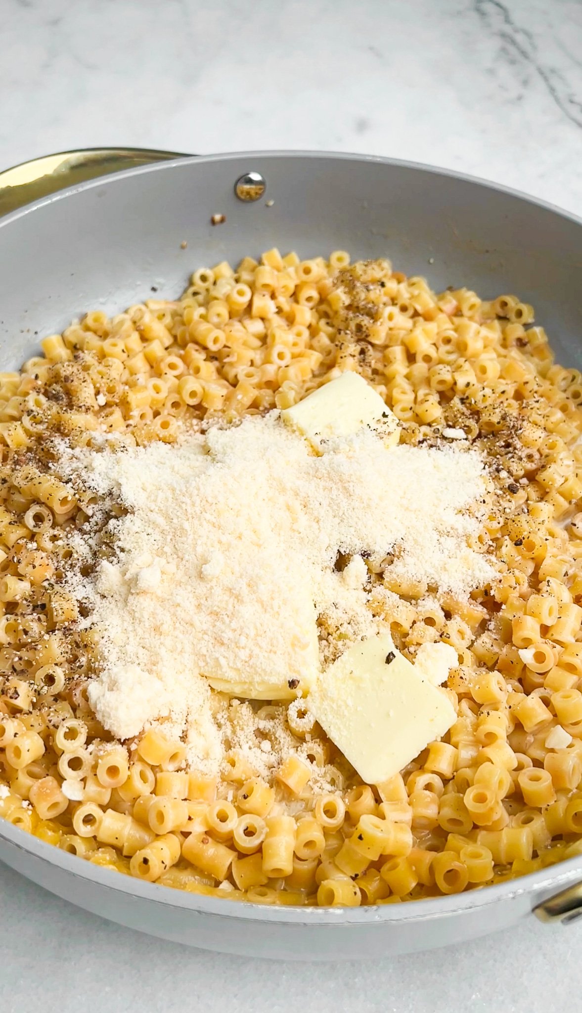 butter and parmesan in to the pan with pasta