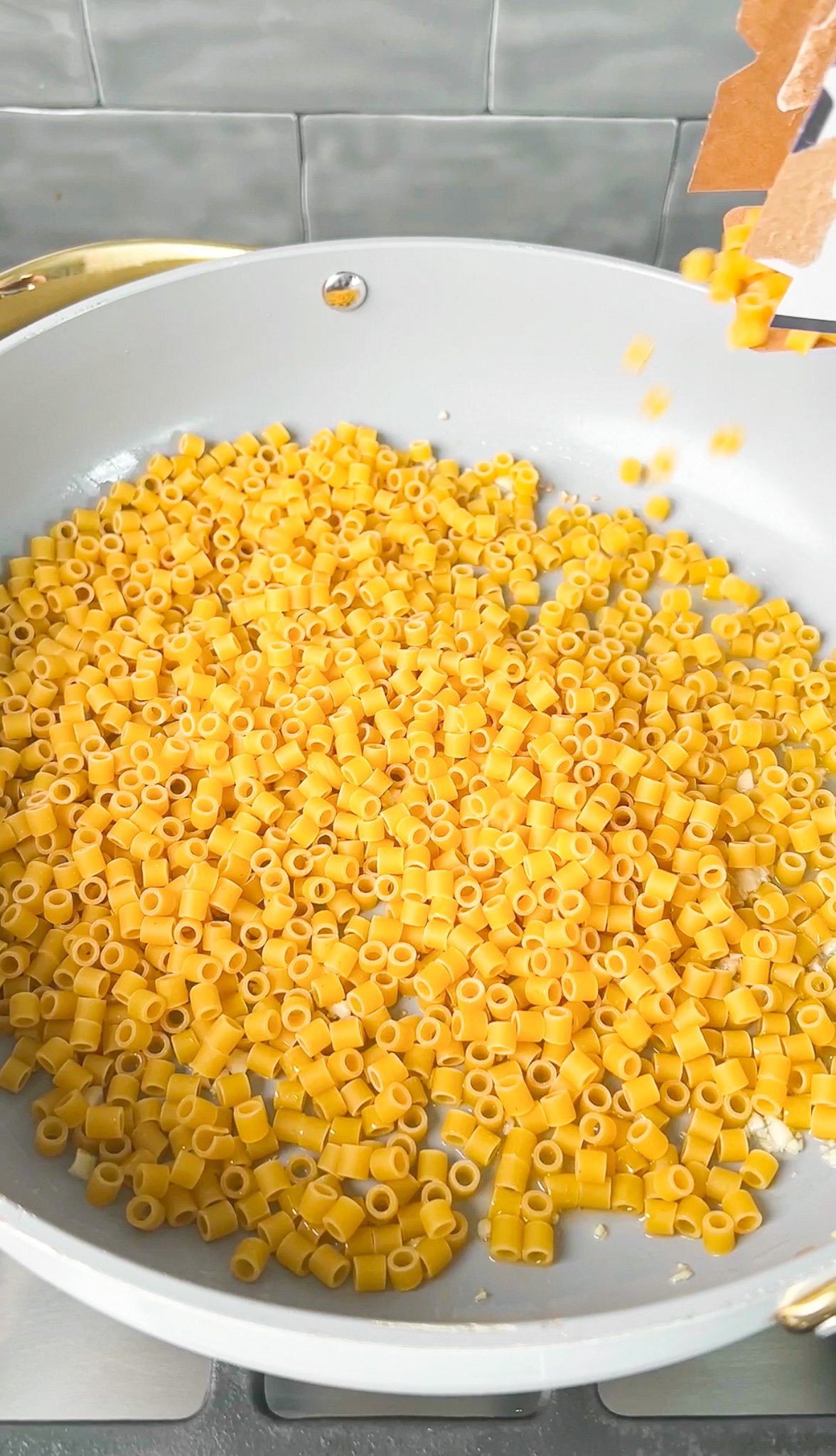 pasta being poured into a pan