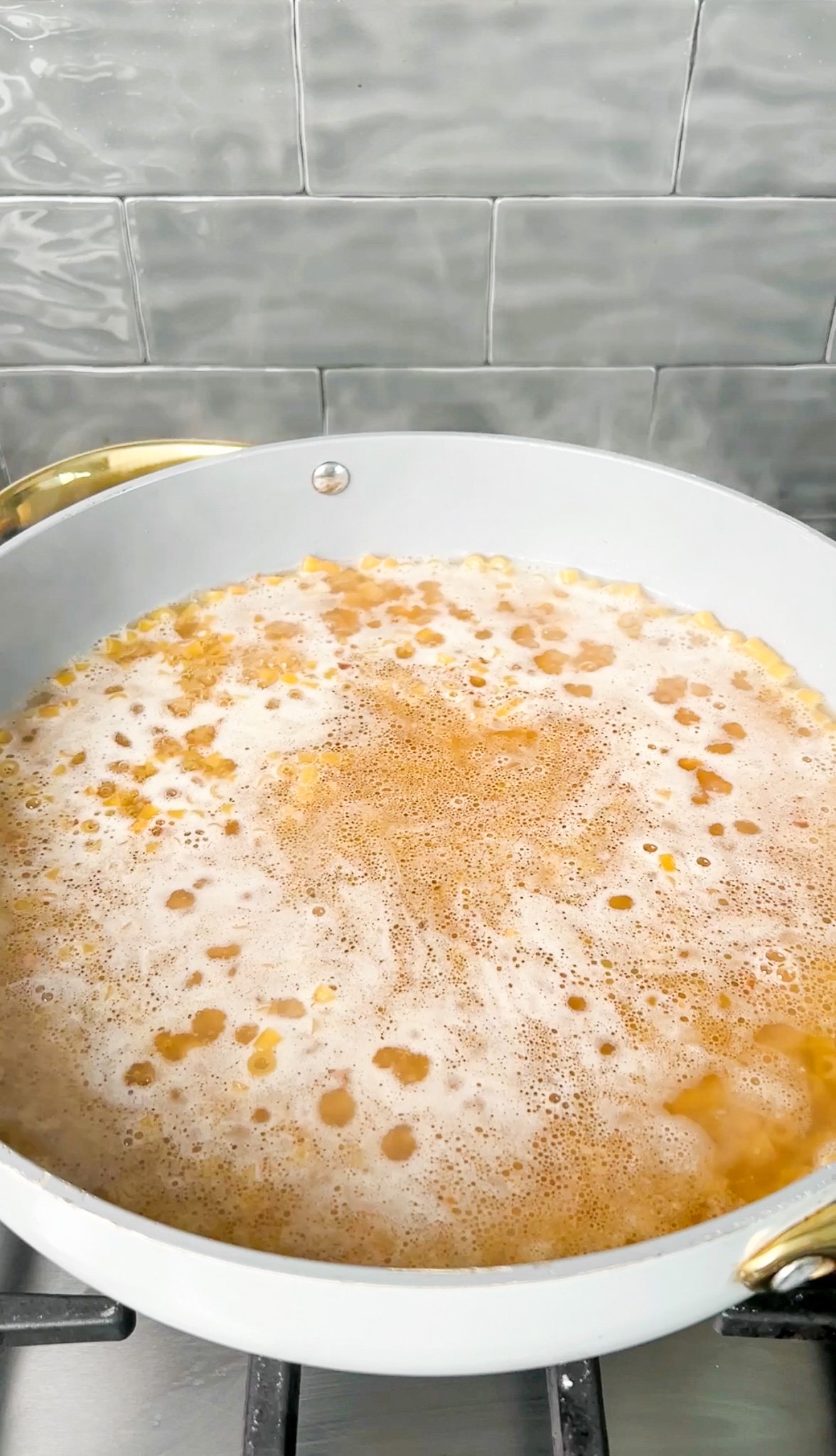 boiling chicken broth in a pan