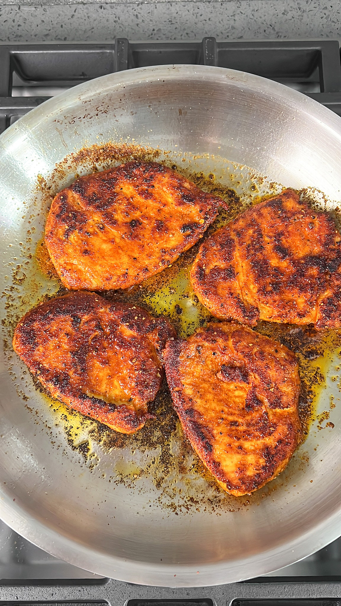 cajun chicken breasts cooking in the skillet