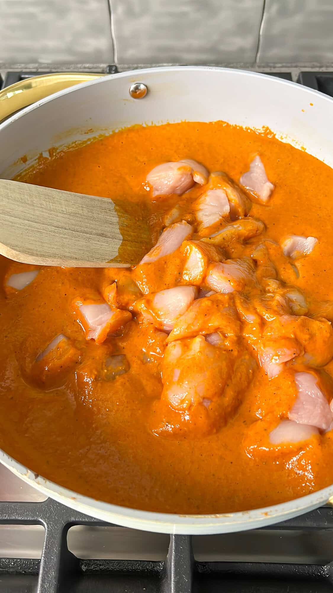 chicken being added into the skillet