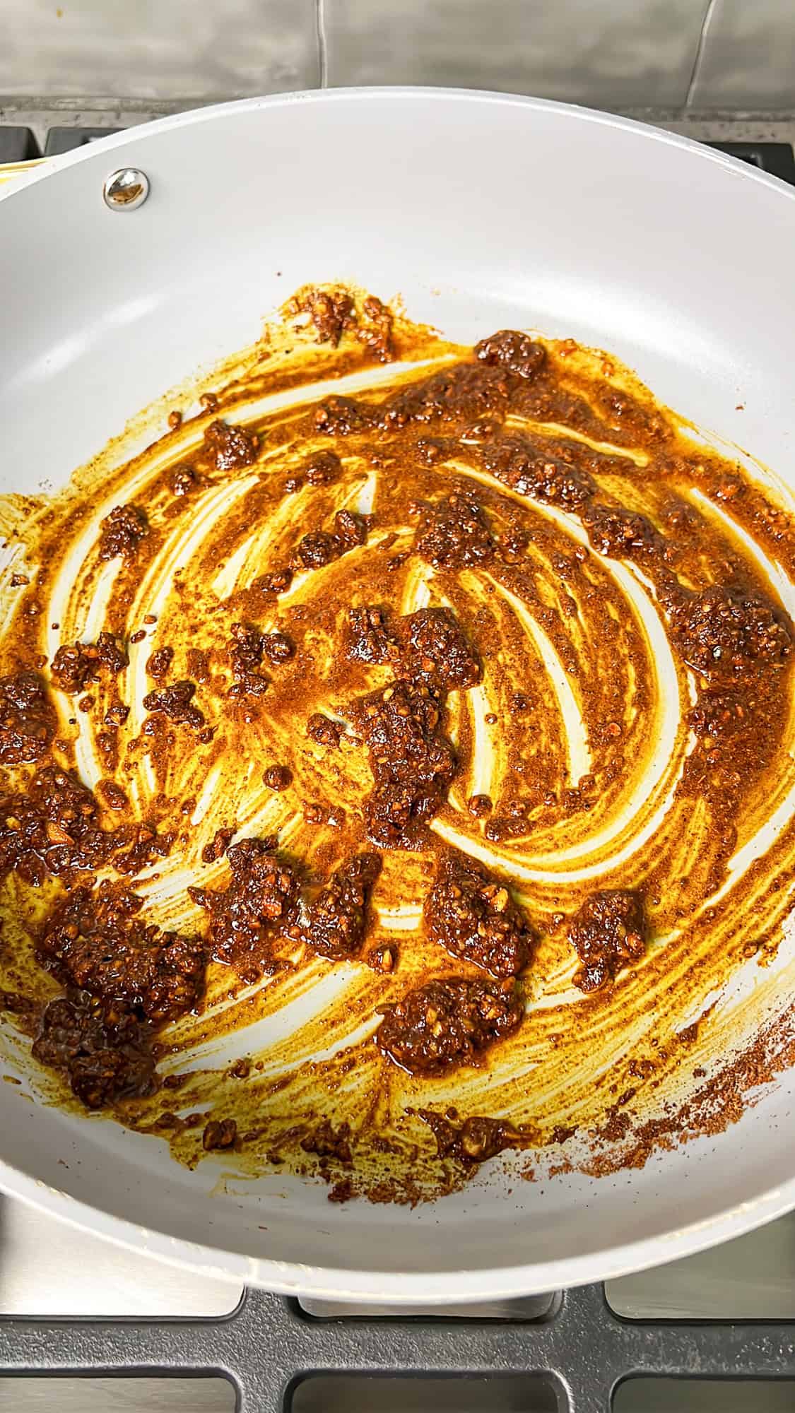 seasonings and garlic sautéing in a pan