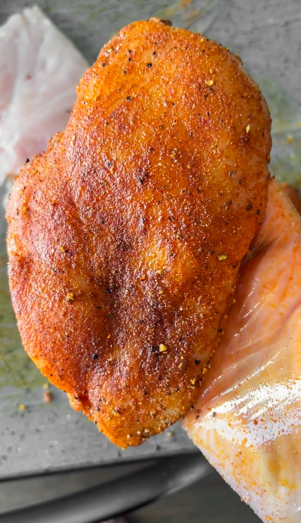 raw chicken covered in seasonings