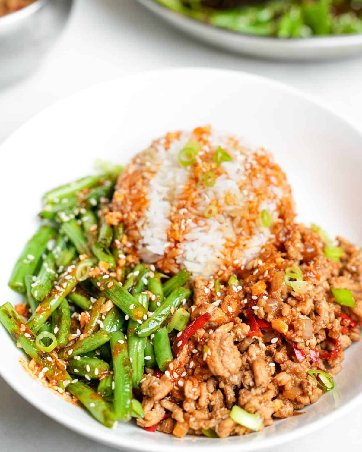 chicken rice and green beans in a bowl
