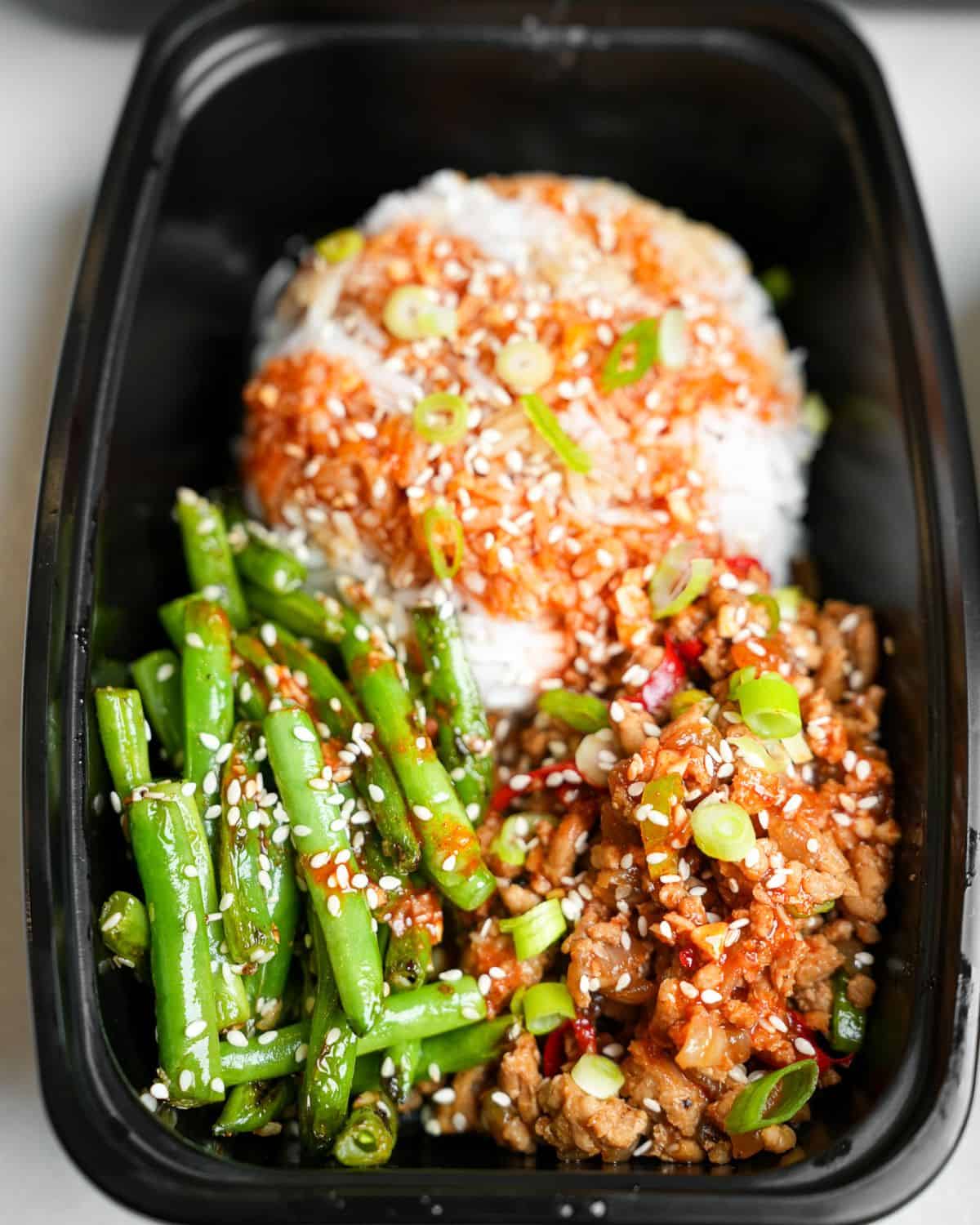 gochujang chicken bowls in a meal prep container