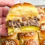 cheeseburger slider being held in hand