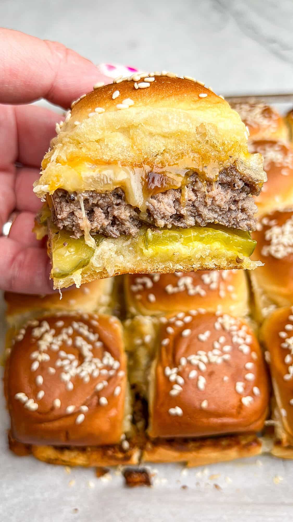 sheetpan cheeseburger slider in hand
