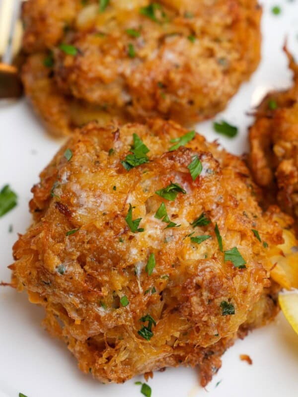 crab cakes on a plate with lemon