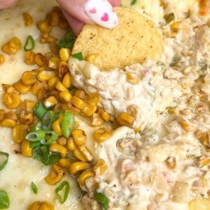 chip dipping in a dish of corn dip