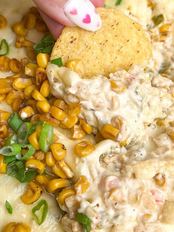 chip dipping in a dish of corn dip