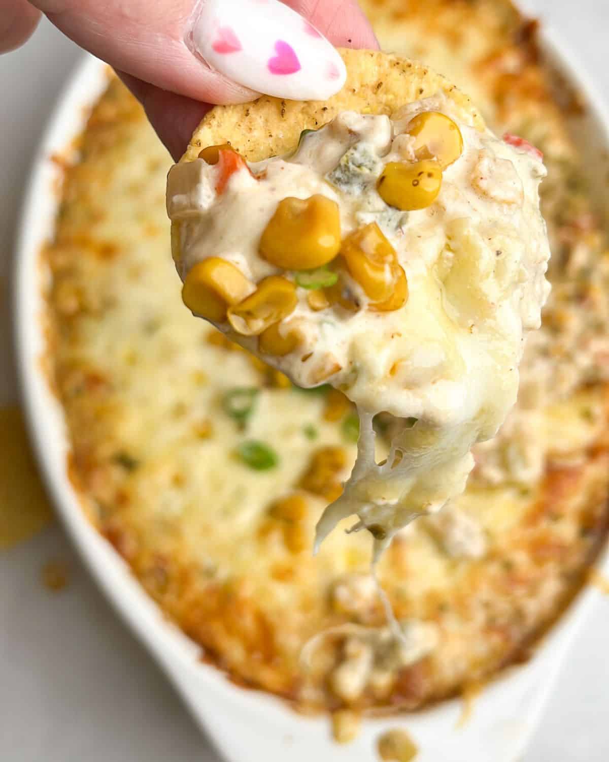 hot corn dip on a tortilla chip