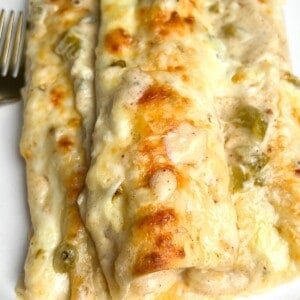 green chile chicken enchiladas on a plate
