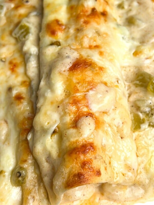 green chile chicken enchiladas on a plate