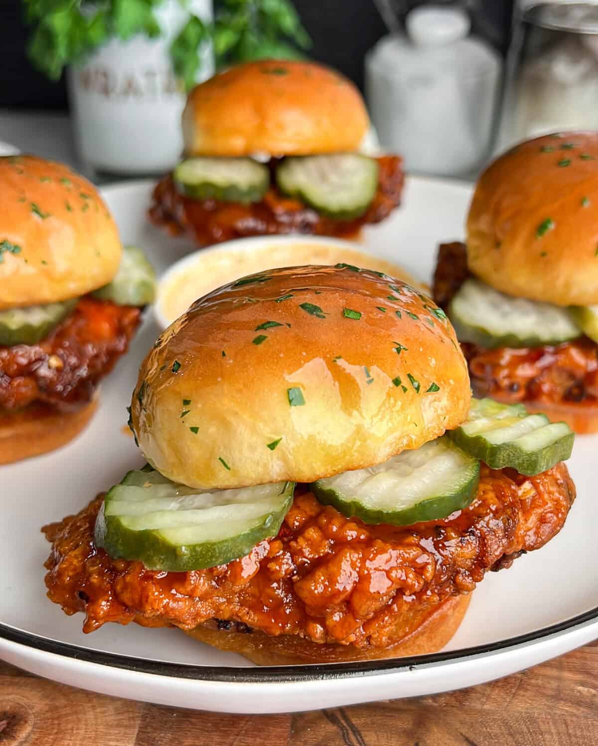 chicken sliders coated in hot honey on toasted slider buns