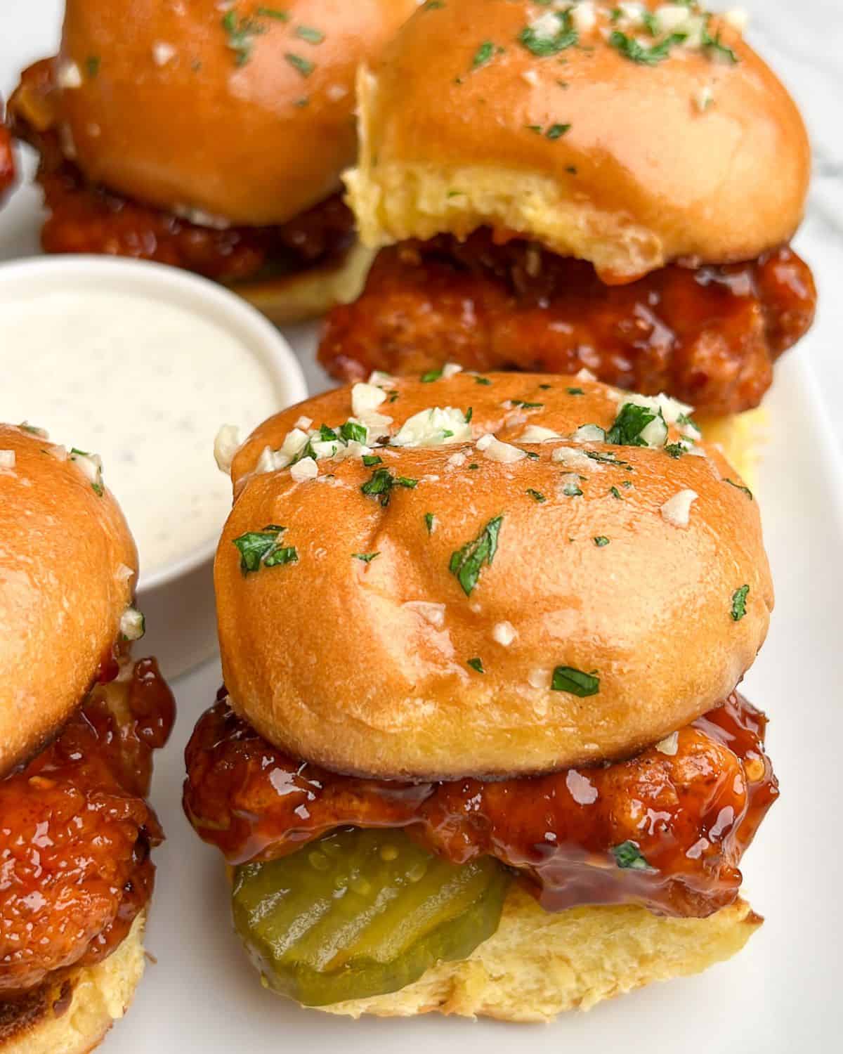 chicken sliders on a plate with ranch dressing