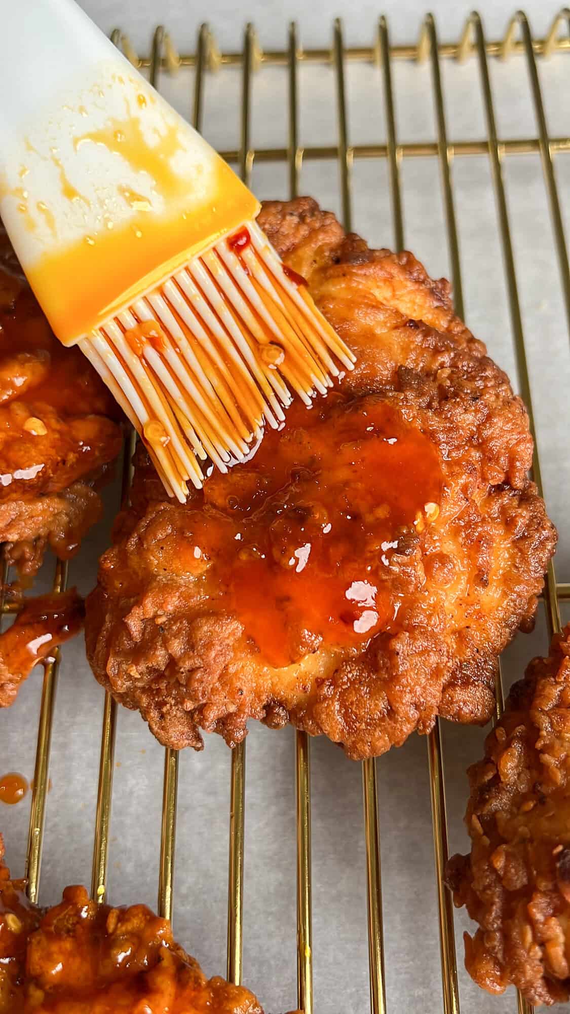 coating the chicken in hot honey sauce