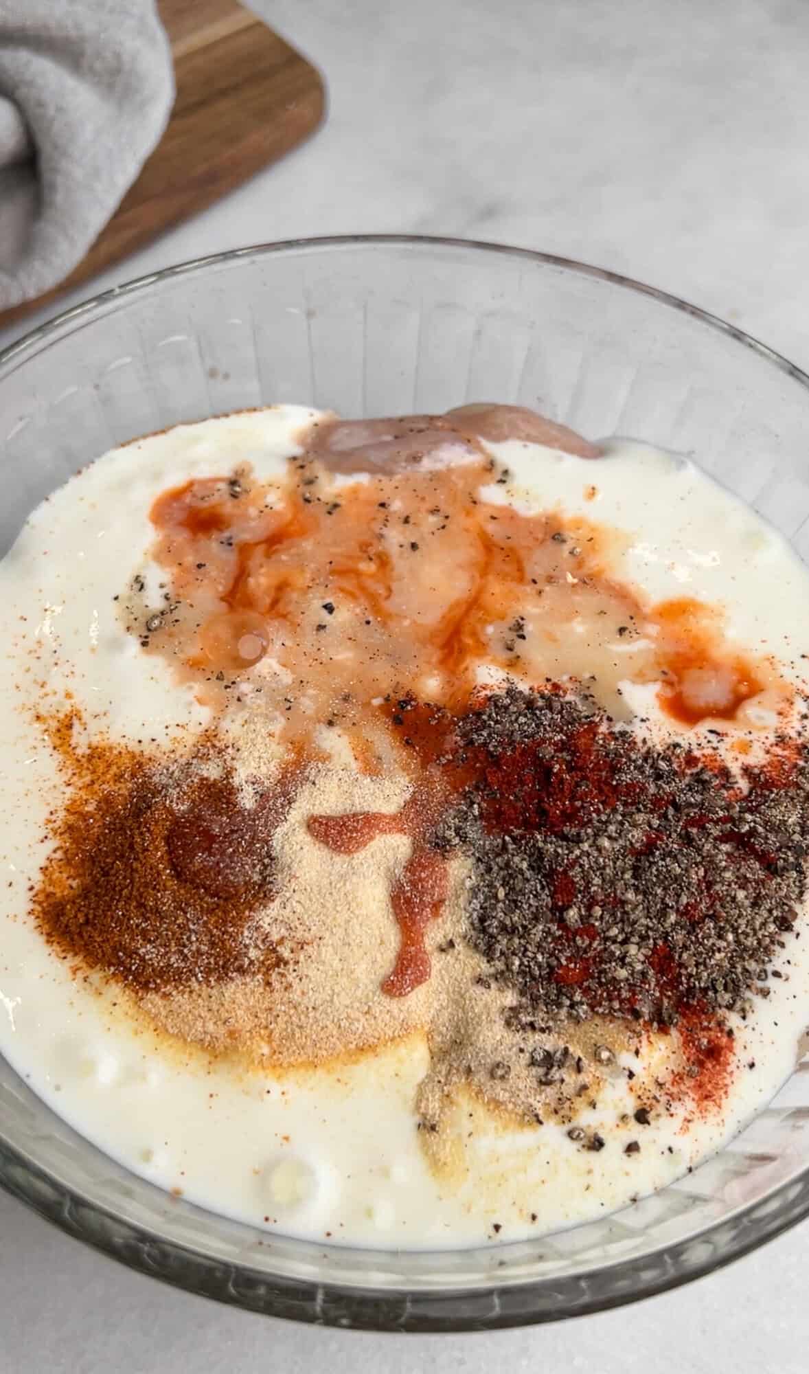 preparing the wet batter for hot honey chicken sliders