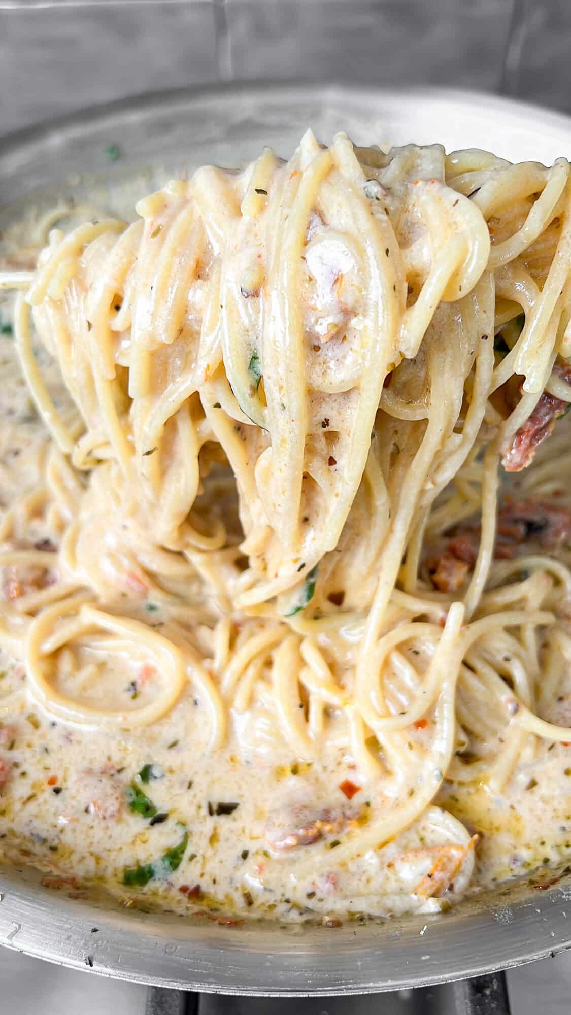 noodles cooking in pan sauce