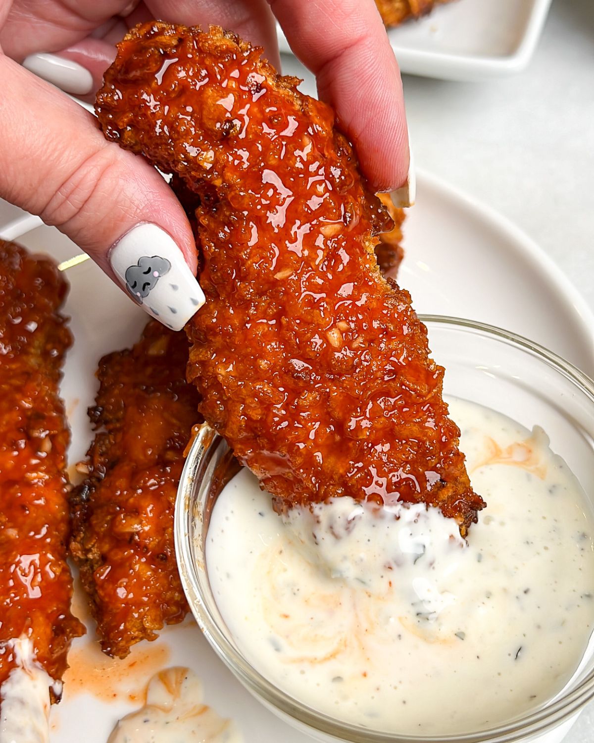 air fried chicken tenders coated in honey buffalo sauce