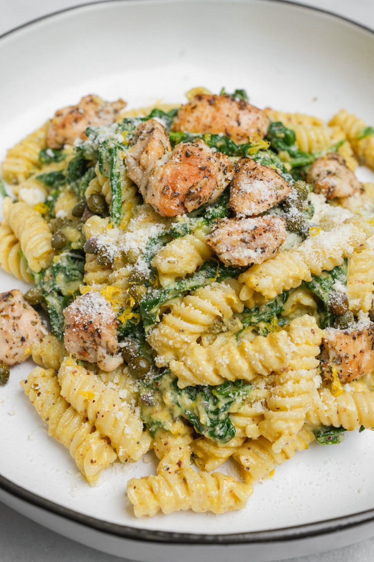 chicken and spinach pasta on a plate