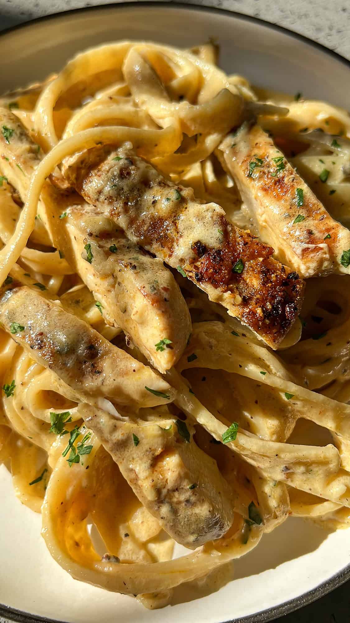 a plate of chicken alfredo sitting on the counter