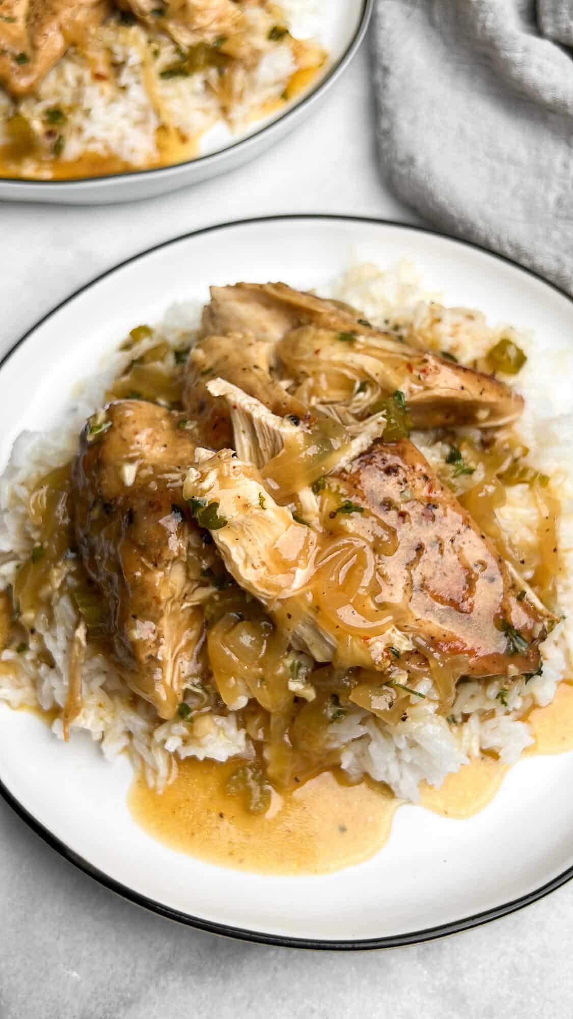 Slow cooker smothered chicken served over rice.