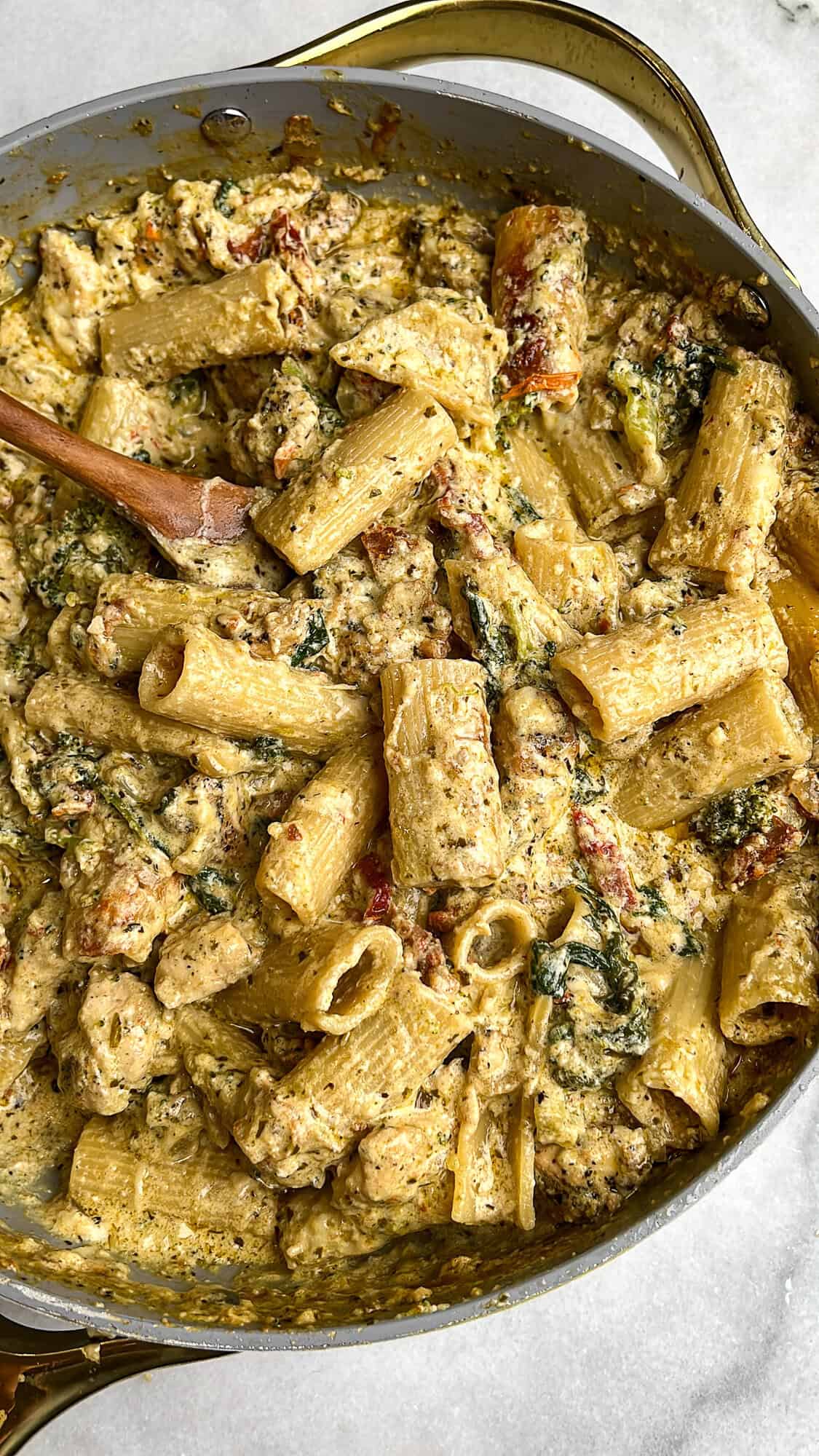 Overhead image of pesto chicken pasta in a skillet.