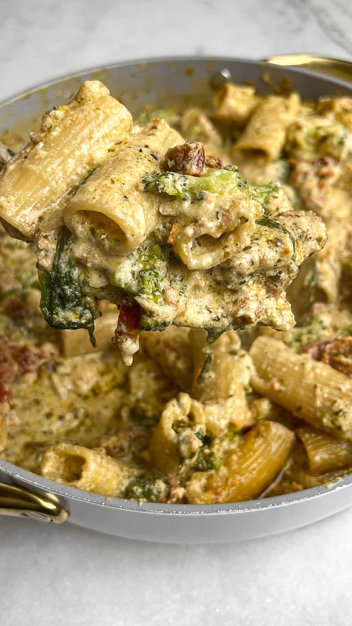 Pesto chicken pasta in a skillet.