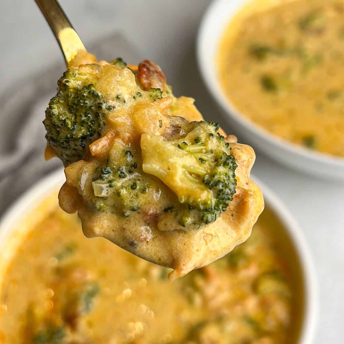 broccoli cheese soup with chicken on a spoon 