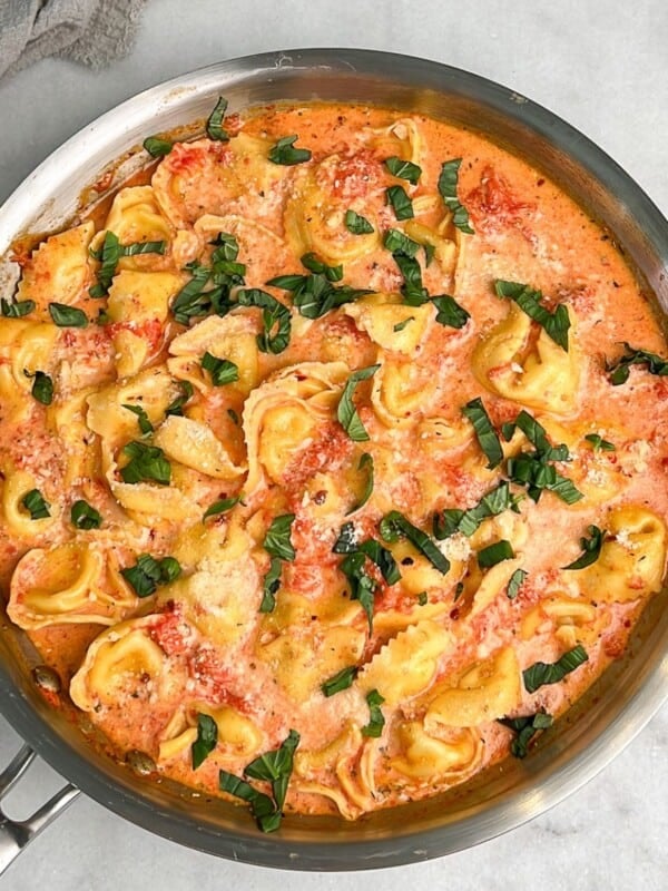 a pan filled with creamy tomato tortellini