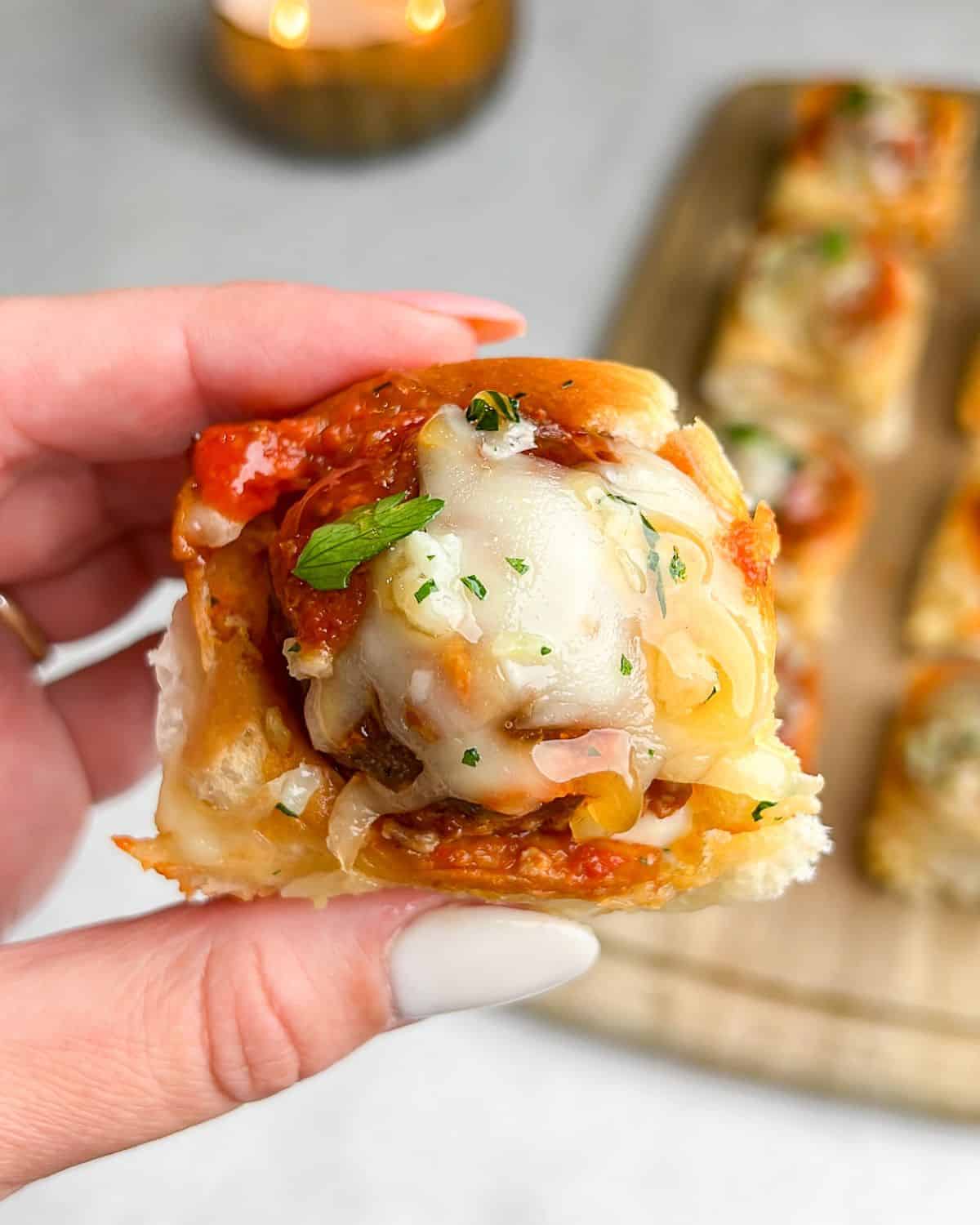 meatball sliders with melted cheese on top and hot honey