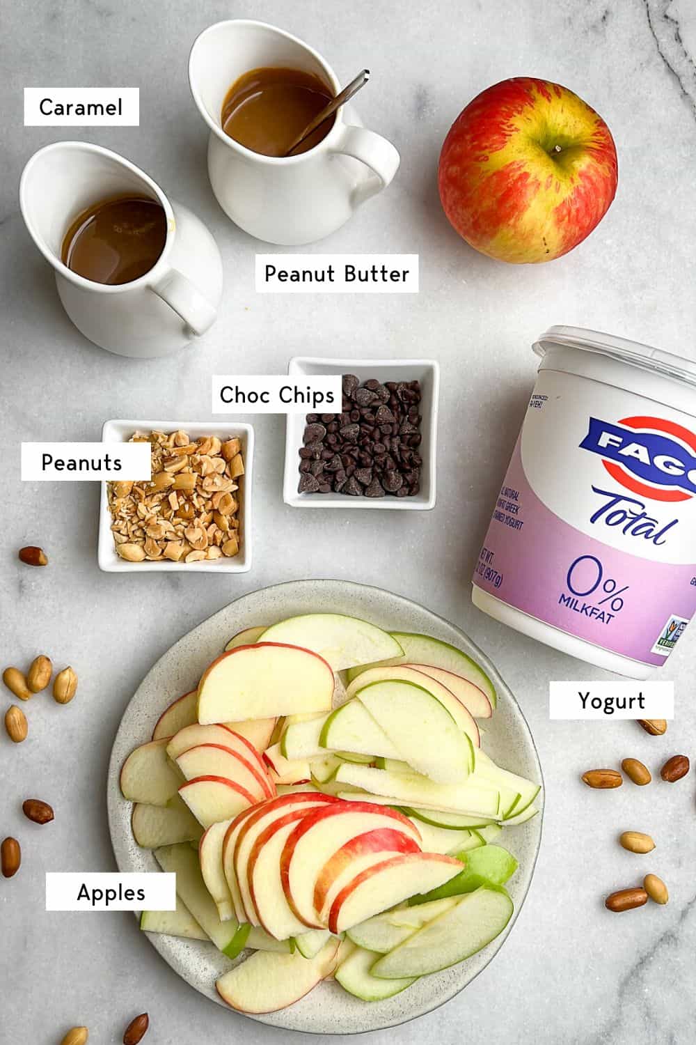 ingredients laid on a tabletop for Snickers apple salad