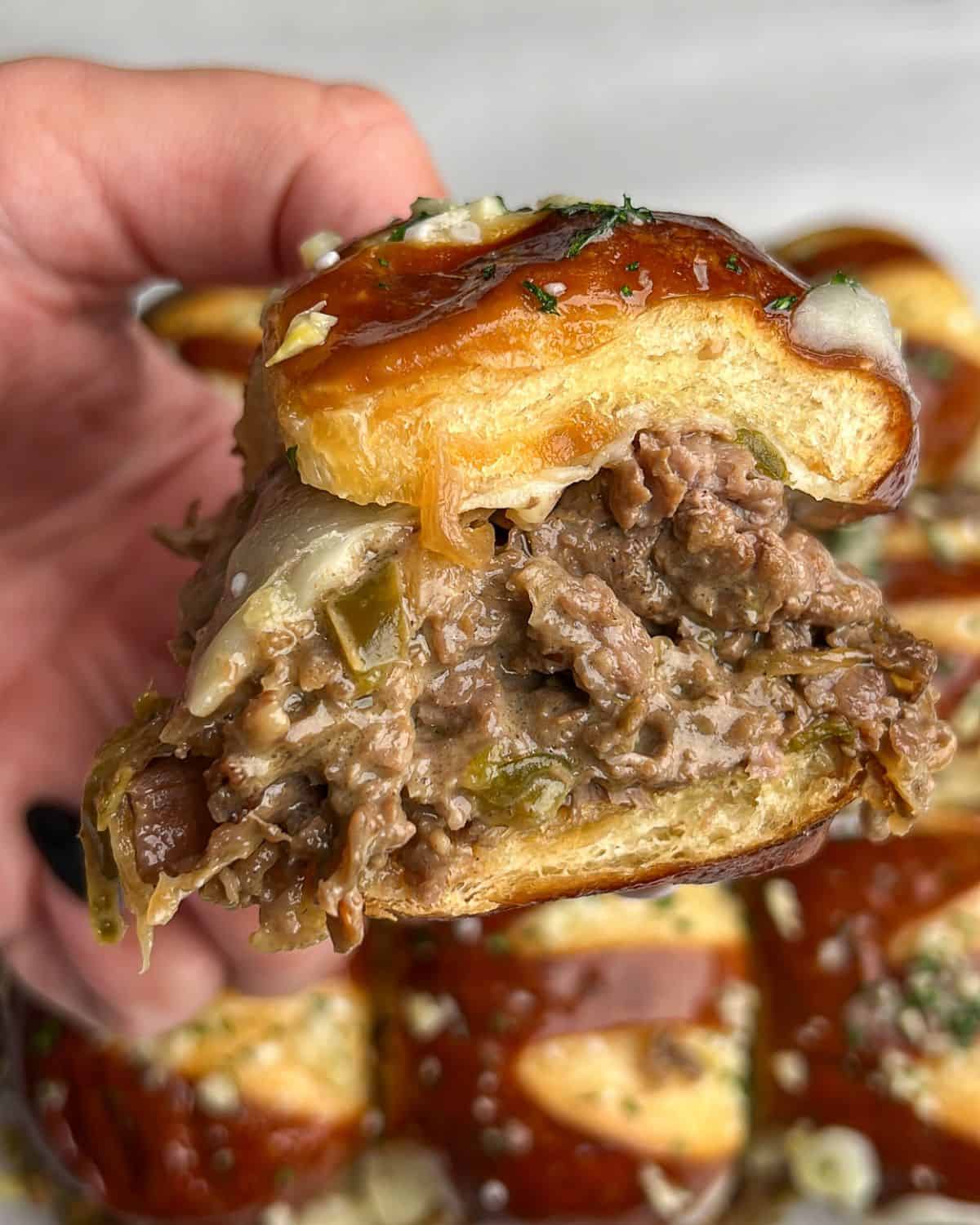 Close-up image of a Philly cheesesteak slider.