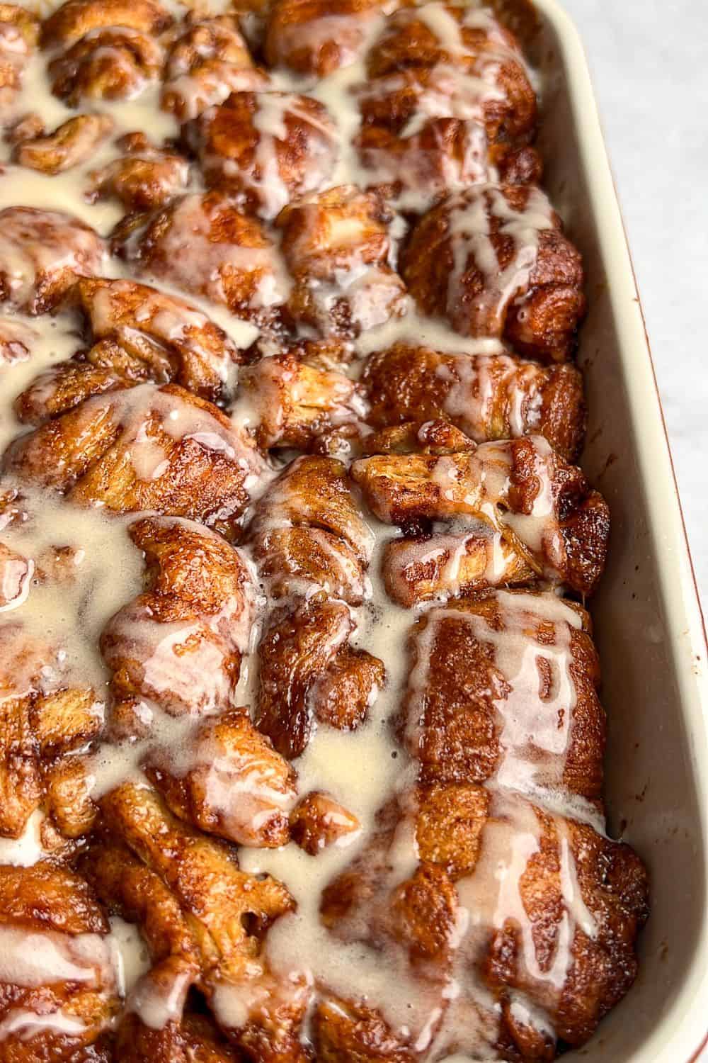 A baking pan full of cinnamon roll bites.