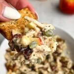 A cracker loaded with chicken salad with apples.