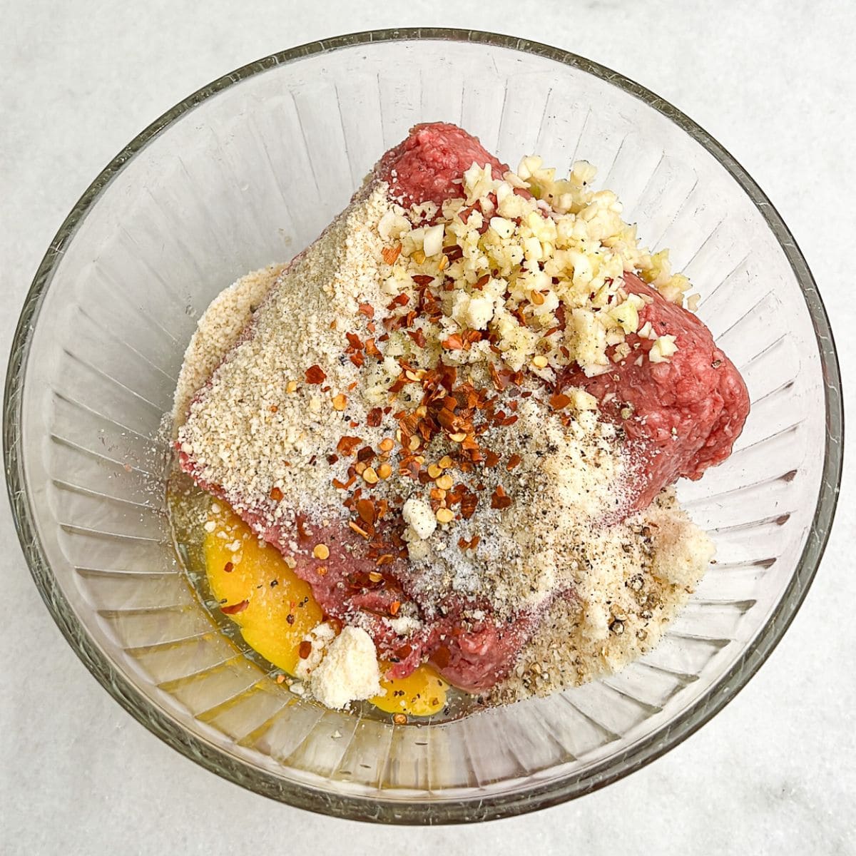 a bowl with all the meatball ingredients