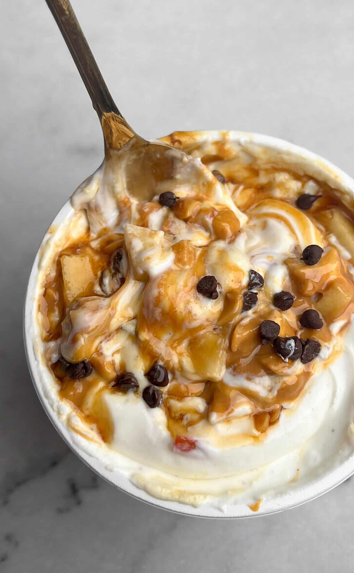 an alternate version to make snickers apple salad, layering the second layer of ingredients into a tub of yogurt