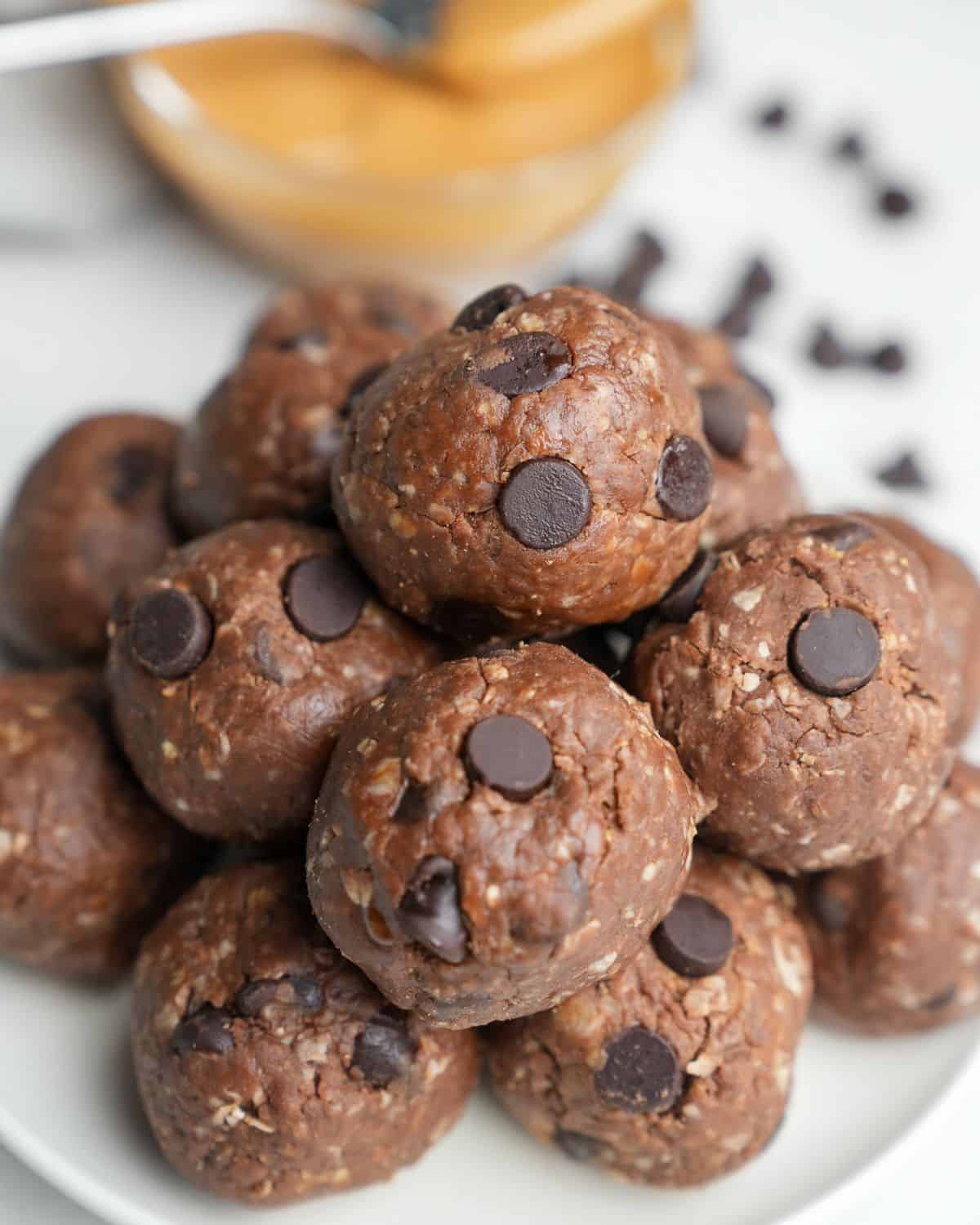 Close-up image of a pile of chocolate peanut butter protein balls on a plate.