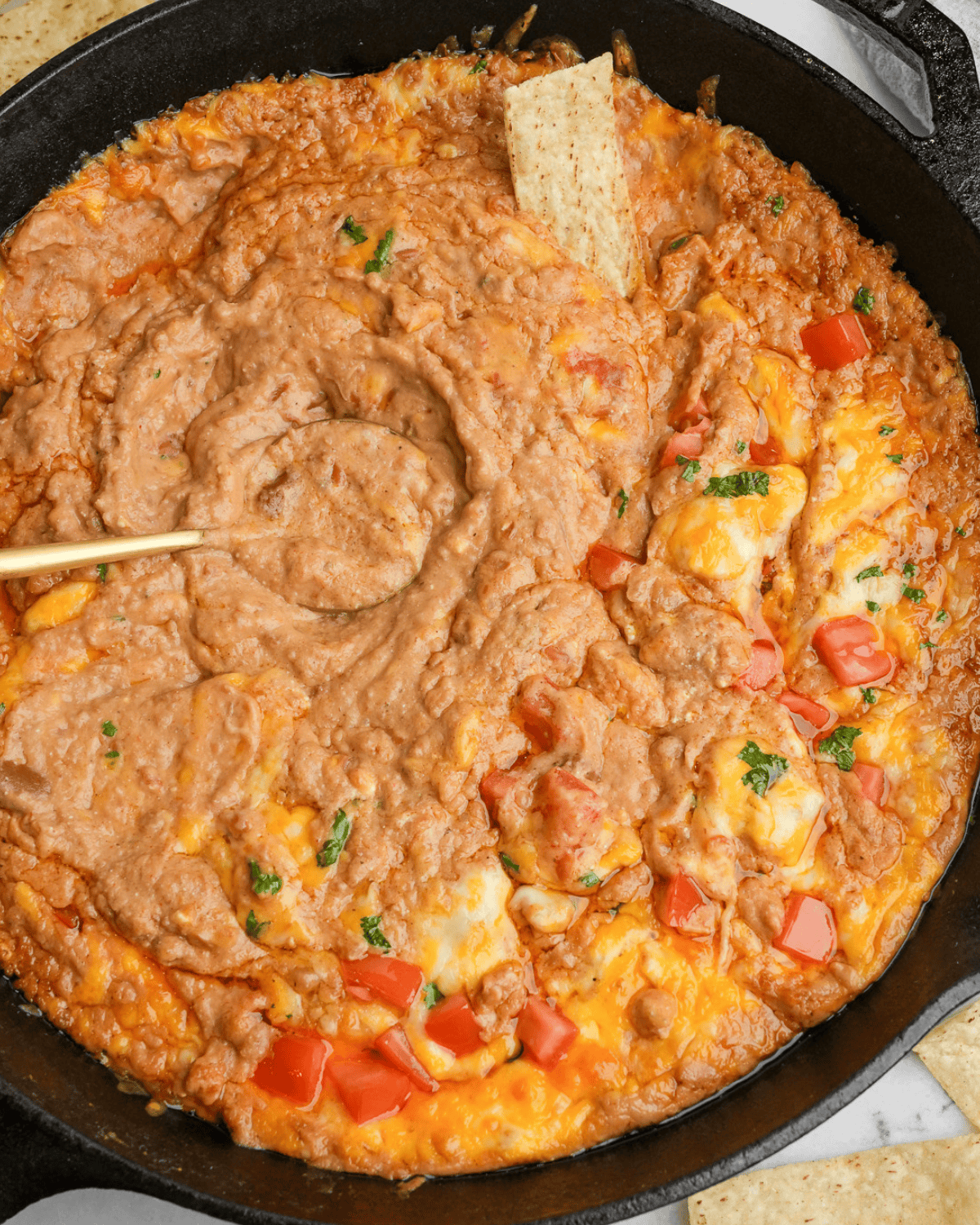 Overhead image of cheesy refried bean dip.
