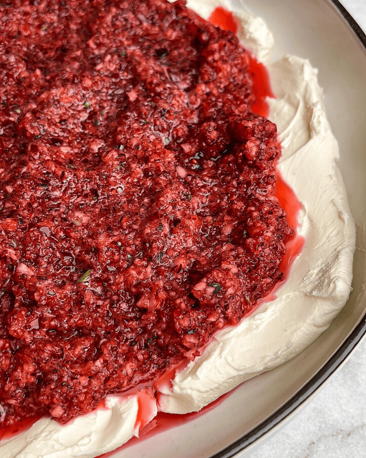 a close up image of the cranberry relish on top of cream cheese